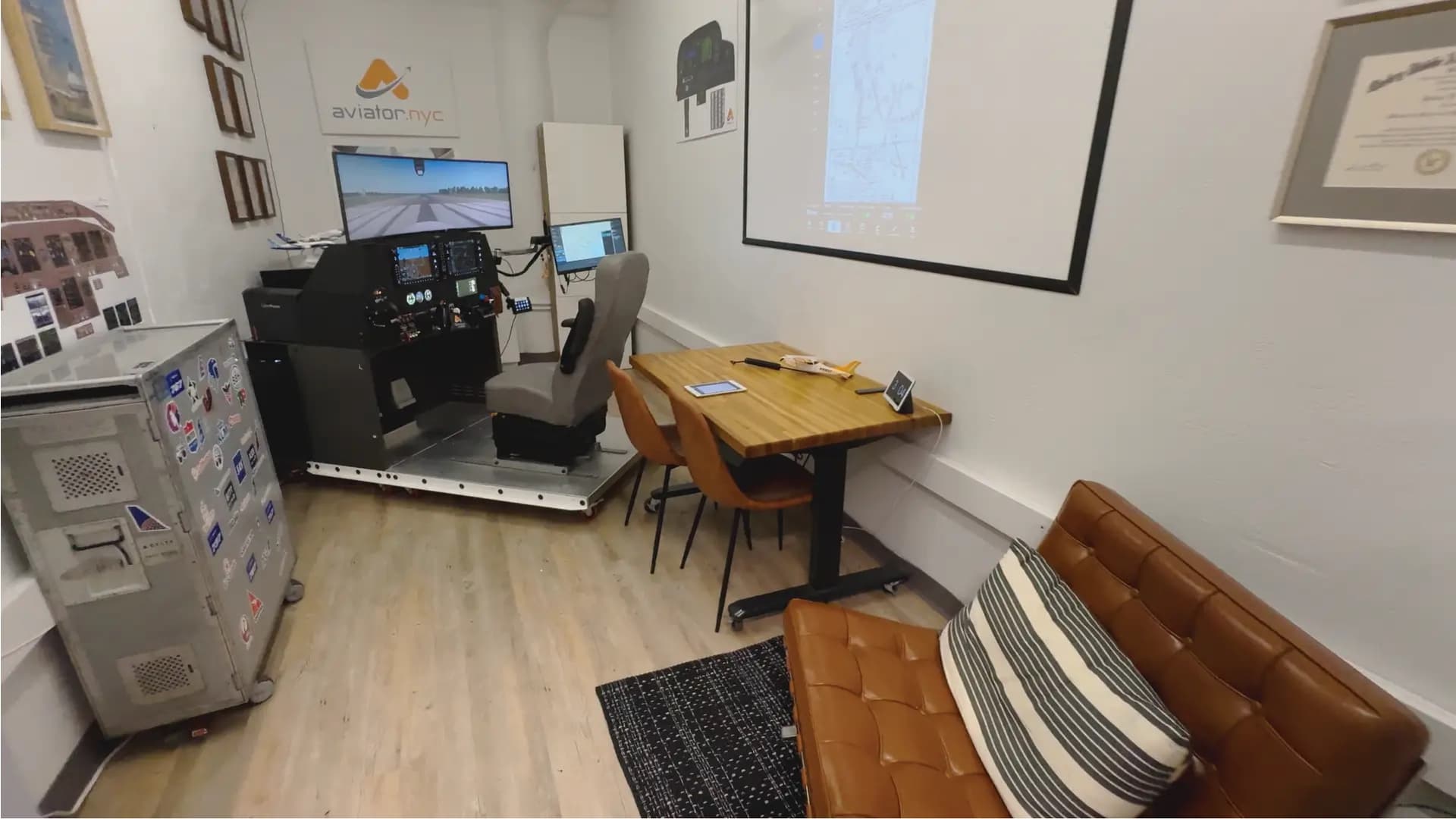 Aviator.NYC studio in Hudson Square — G1000 AATD simulator, briefing area, and lounge