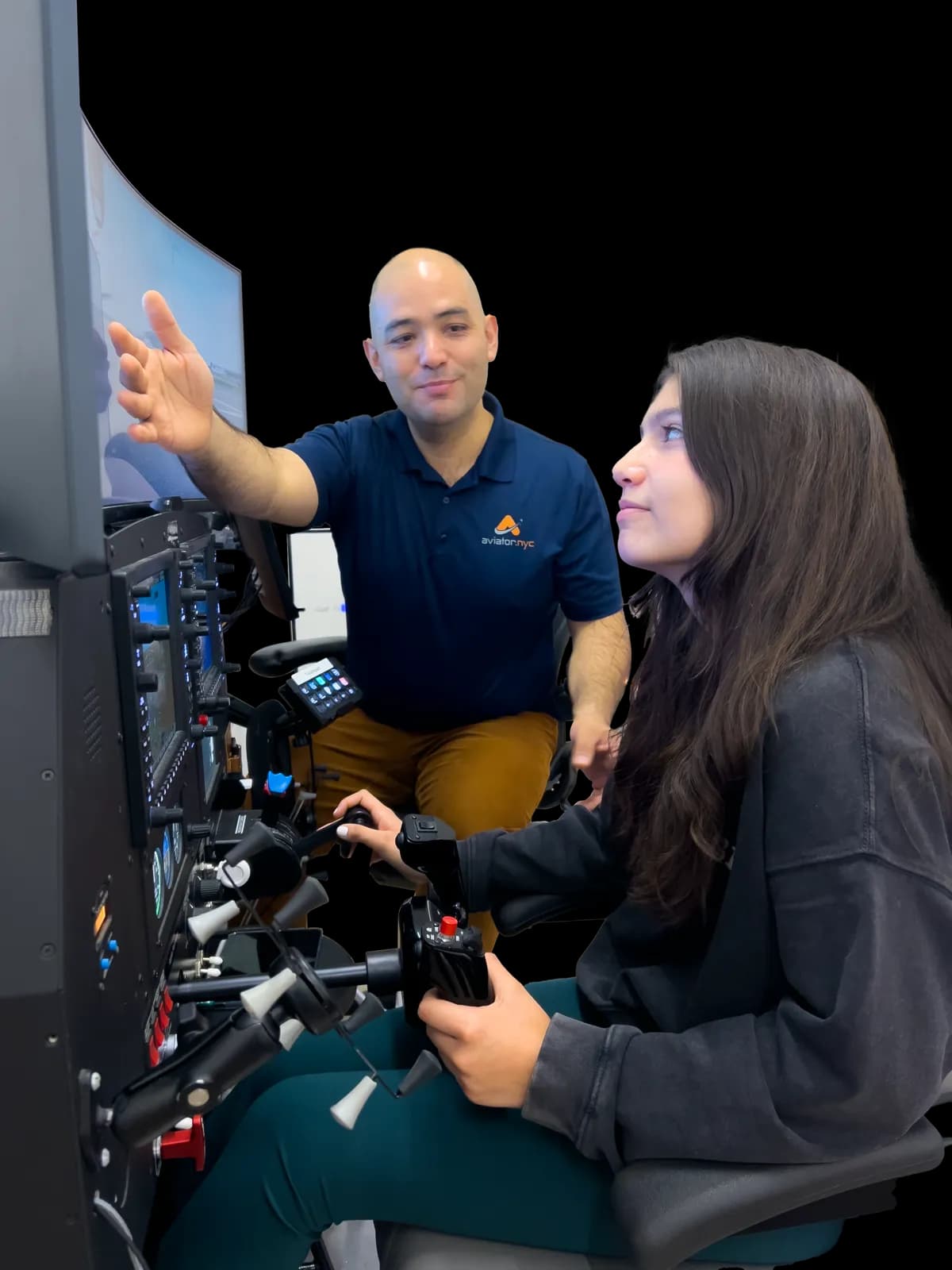 Aviator.NYC instructor teaching a student at the flight simulator in the Manhattan studio