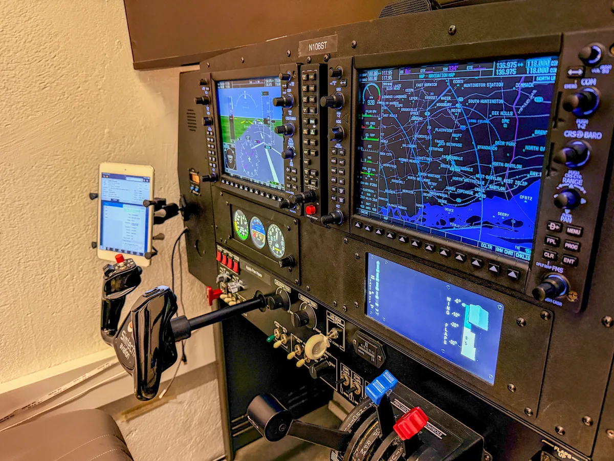 G1000 NXi avionics panel close-up showing PFD, MFD, standby instruments, and ForeFlight iPad at Aviator.NYC flight simulator in Manhattan
