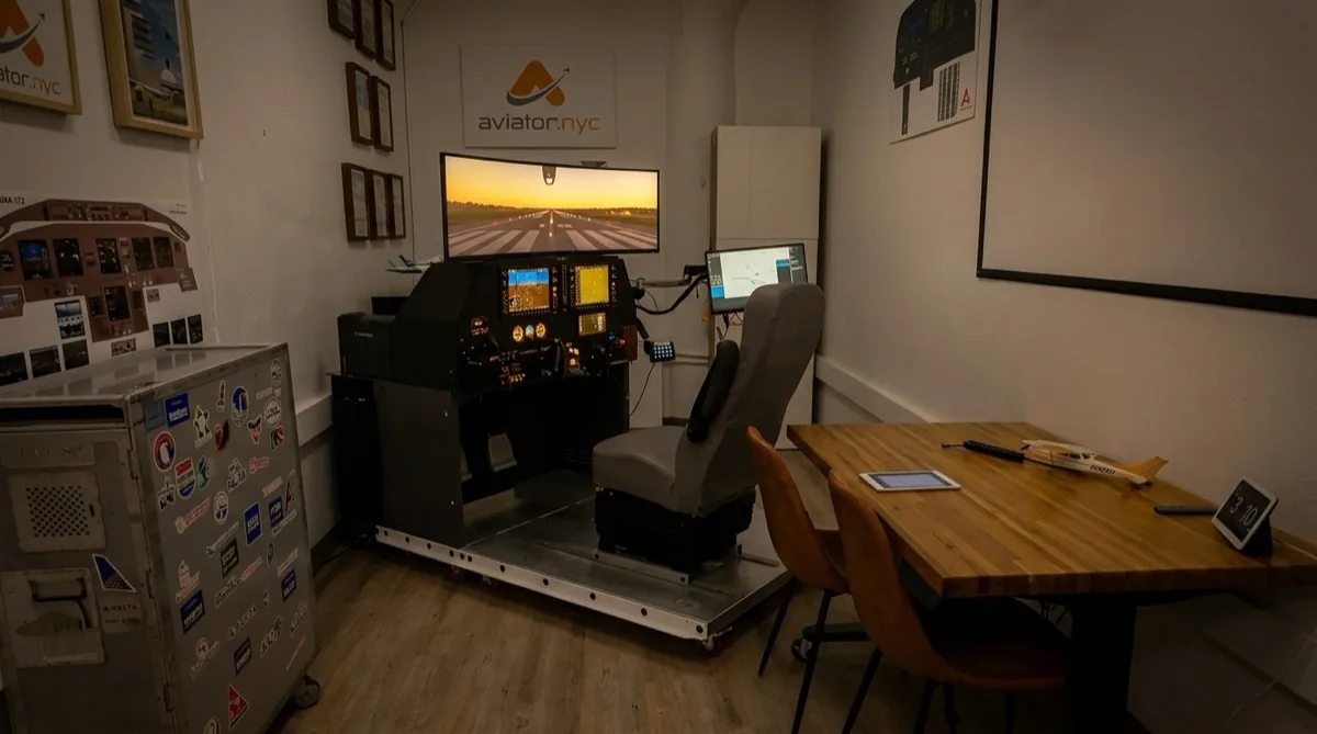 Aviator.NYC PFC GTX flight simulator showing sunset runway approach — G1000 NXi cockpit with warm evening lighting in Manhattan training facility