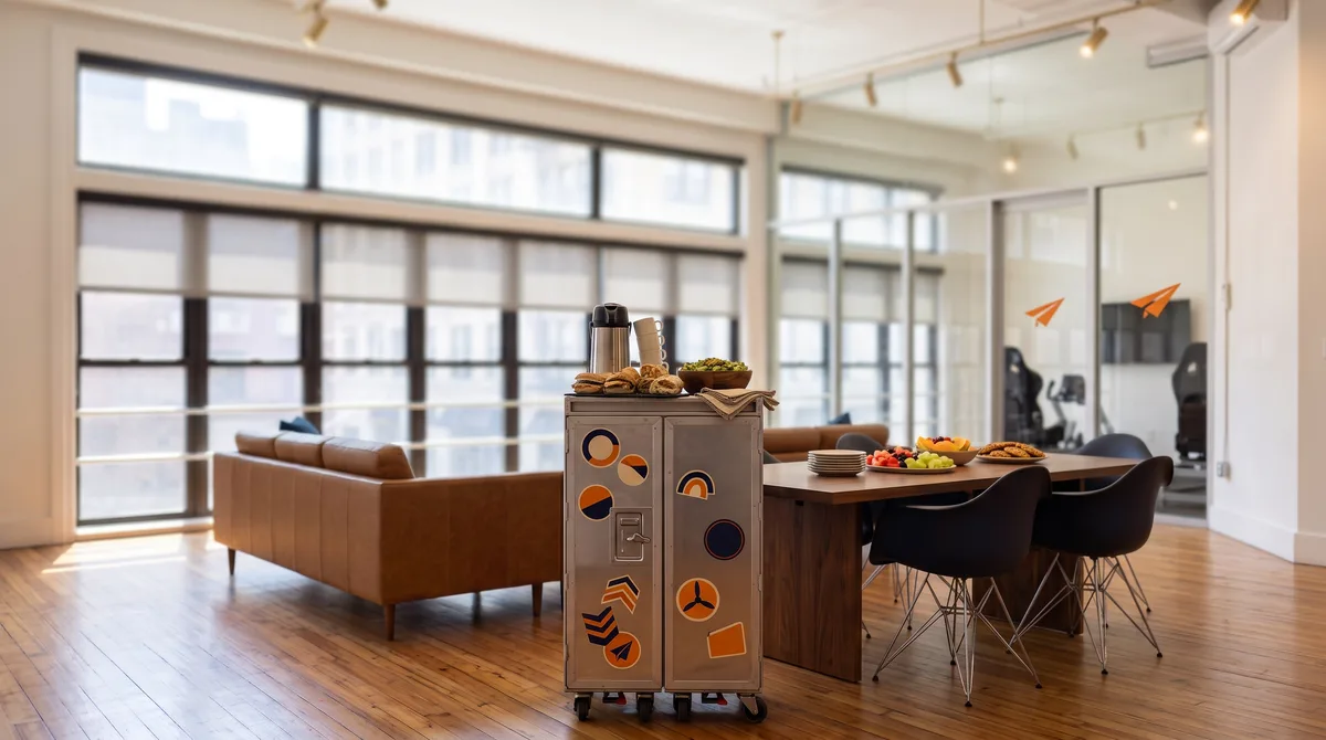 AI-generated rendering of an arranged catering spread on the airline galley cart in the window-end lounge of the planned Midtown studio