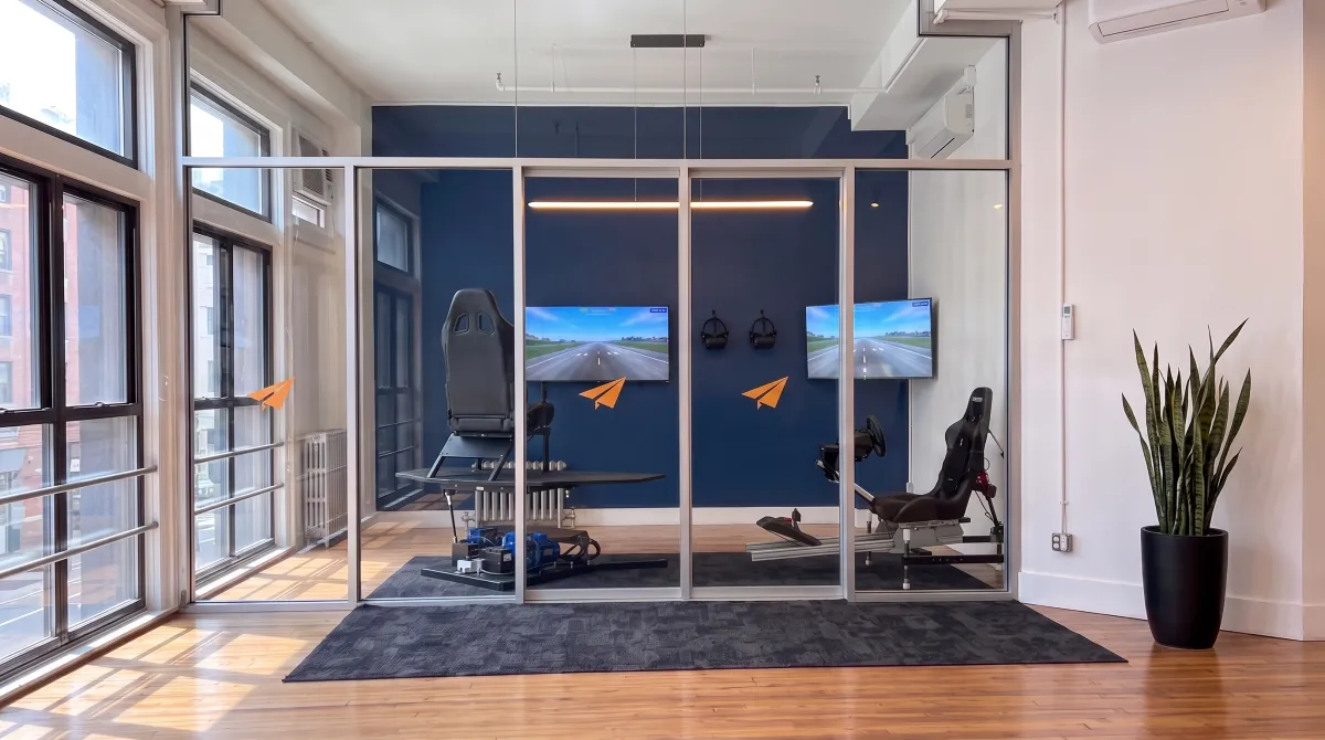 AI-generated rendering of the two motion VR flight simulators inside the glass-walled VR room